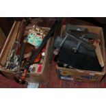 Two boxes of violin and musical instruments spare parts including strings, clamps, cello bridges,