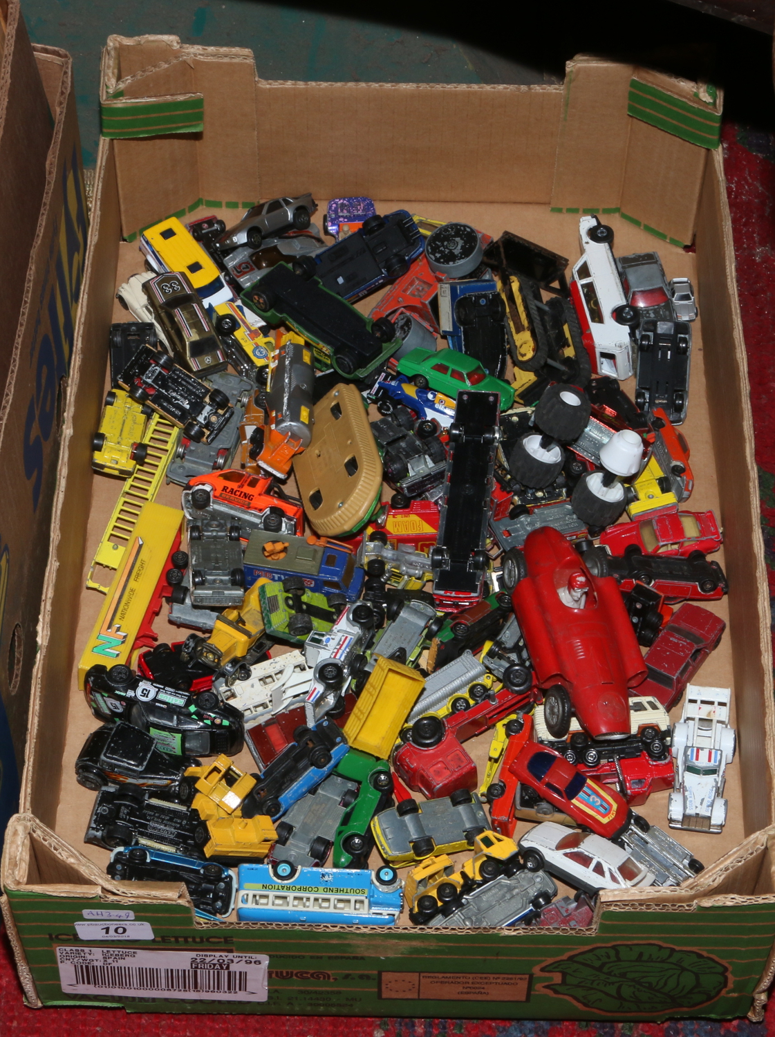 A box of mainly Matchbox Diecast toy vehicles.