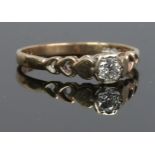 A 9ct gold solitaire diamond ring with pierced heart design shoulders. Size M.