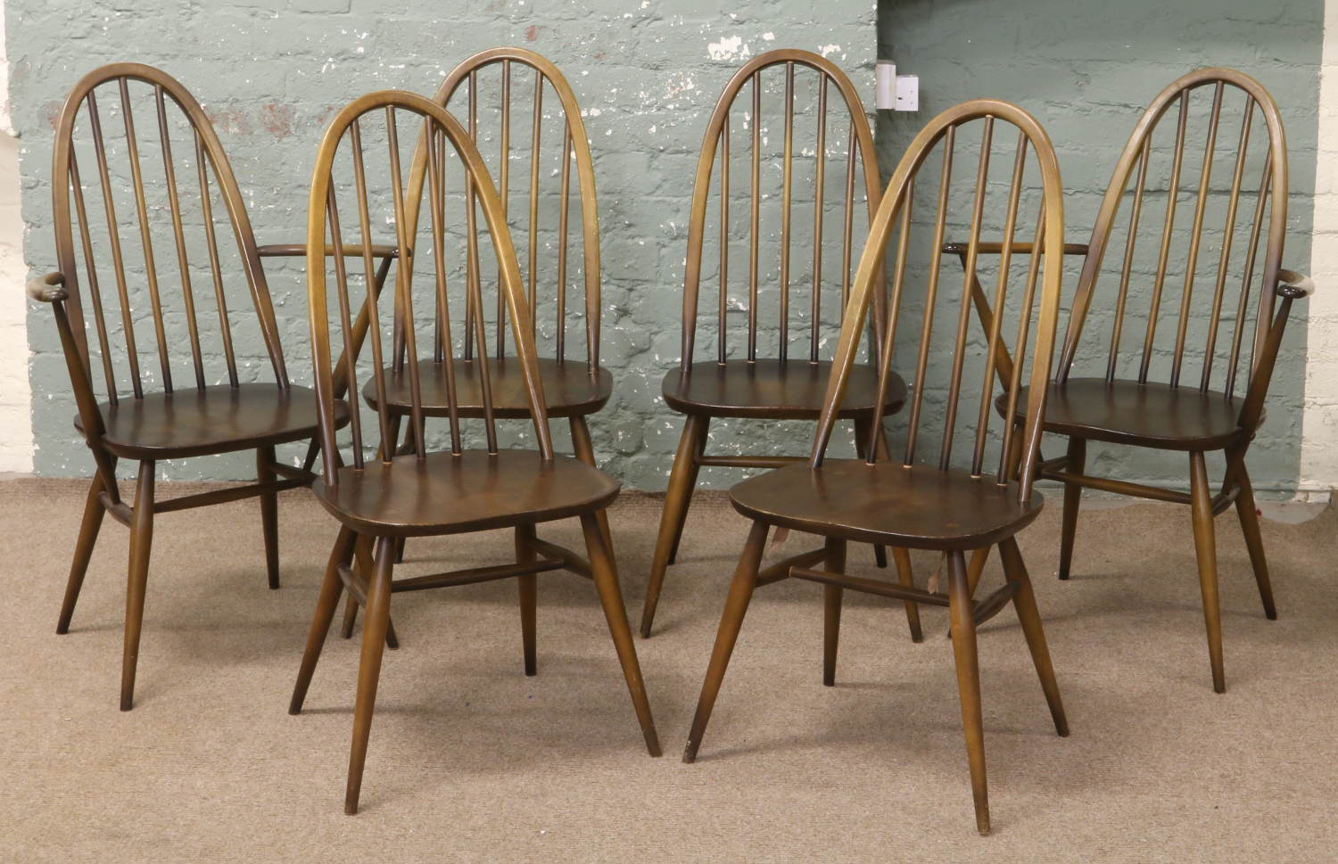 A set of six Ercol Quaker style dining chairs including two carvers. Condition Report.