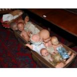 Two boxes of vintage dolls including celluloid examples along with a wicker dolls pram.