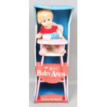 A boxed Rosebud baby angel in high chair.