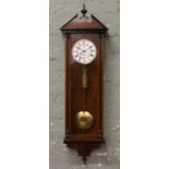 A walnut cased 19th century 8 day Vienna wall clock white and brass dial, Roman numeral markers,