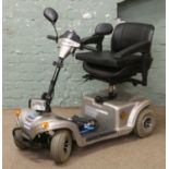 A Wheel Tech Monami Vitesse mobility scooter with charger cover and documents.