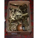 A box of brassware to include trivets, candlesticks etc.