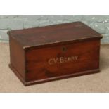 A vintage pine storage chest stencilled C. V. Berry.