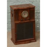 A burr walnut effect C.D player with MW/FM radio tuner and built in C.D storage.