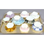 A collection of bone china cups and saucers to include trio.