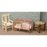 Two bisque dolls, along with a painted crib, painted chair and rush seat stool.