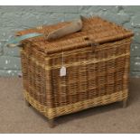 A wicker basket with a teal shoulder strap.