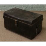 A tin trunk with twin handles.