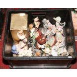 A box of decorative figurines including Leonardo collection examples.