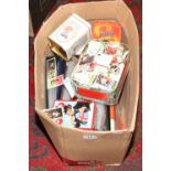 A box of various collections of cigarette cards in tins and in albums.