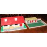 A dolls house bungalow with stables and paddock.