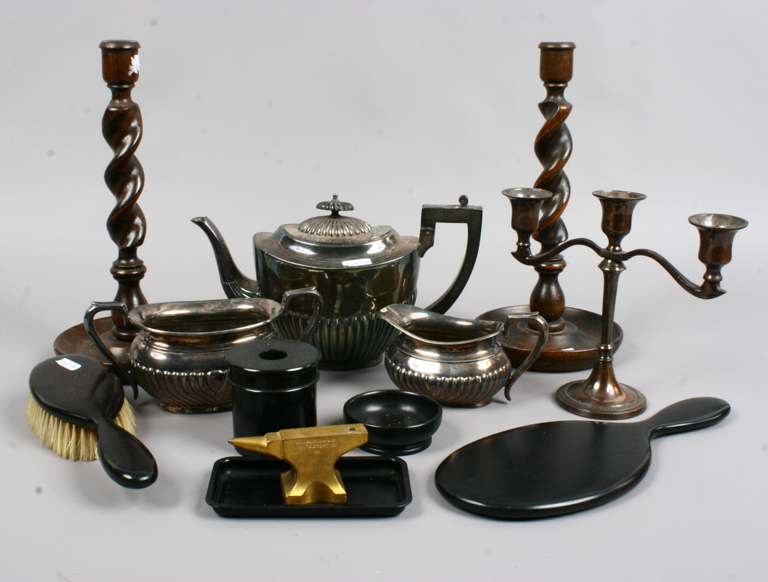 A collection of metal and wooden items to include silver plate teaset, ebony dressing table set,