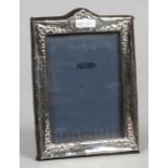 An ornate silver photograph frame assayed London 1981, by Reyford Frames Limited.