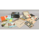 A box of mixed ephemera to include two first day edition Harry Potter books, postcards, sports