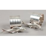 A pair of novelty silver plated napkin rings mounted with fish.