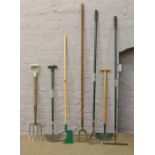 A quantity of garden tools including fork, rake, hoe etc.