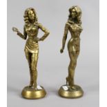 A pair of brass figures the originals cast in silver for a fashion magazine.