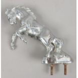 A chrome effect car mascot formed as a rearing horse.