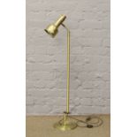 A brushed brass effect floor standing reading lamp.