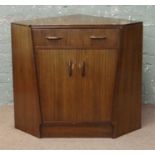 A vintage teak retro G-plan Gomme corner cabinet with secretaire drop down writing shelf.