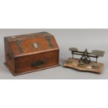 An oak metal bound desk stand along with a set of postal scales with weights.