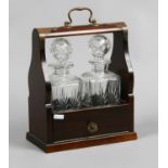 A metal bound mahogany tantulas with two cut glass decanters.