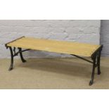 A cast iron garden table with two plank oak top.