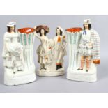 A pair of Staffordshire flat back figures of a lady and gent in Scottish dress, along with a