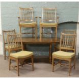 A Stag extending dining table and set of six chairs including two carvers.