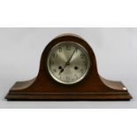 A mid 20th century oak cased mantle clock housing a two train movement with pendulum and key.