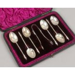 A cased set of six Victorian silver teaspoons with apostle terminals and matching pair of sugar