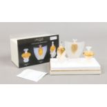 A boxed Lalique trio of miniature glass scent bottles and scent, Les Flancons miniatures.