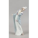 A Lladro figure of a maiden, one finger lacking.