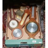 A box of banjo barometers and mantle clocks.