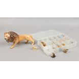 A Beswick model of a lion and an assortment of wade whimsies.