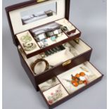 A burgundy leather effect jewellery box and contents of costume jewellery including earrings,