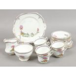 An early 20th century New Chelsea bone china part tea service decorated in the Fairy Village pattern