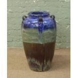 A large glazed terracotta floor standing vase, height 72cm.