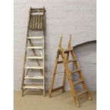 Two pairs of wooden step ladders.