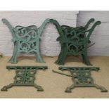 Three pairs of painted cast iron bench ends and a pair of cast iron table ends.