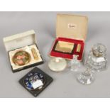 A glass inkwell, Russian enamel powderbowl, three boxed compacts including Stratton and two