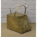 A brass coal scuttle with shovel.