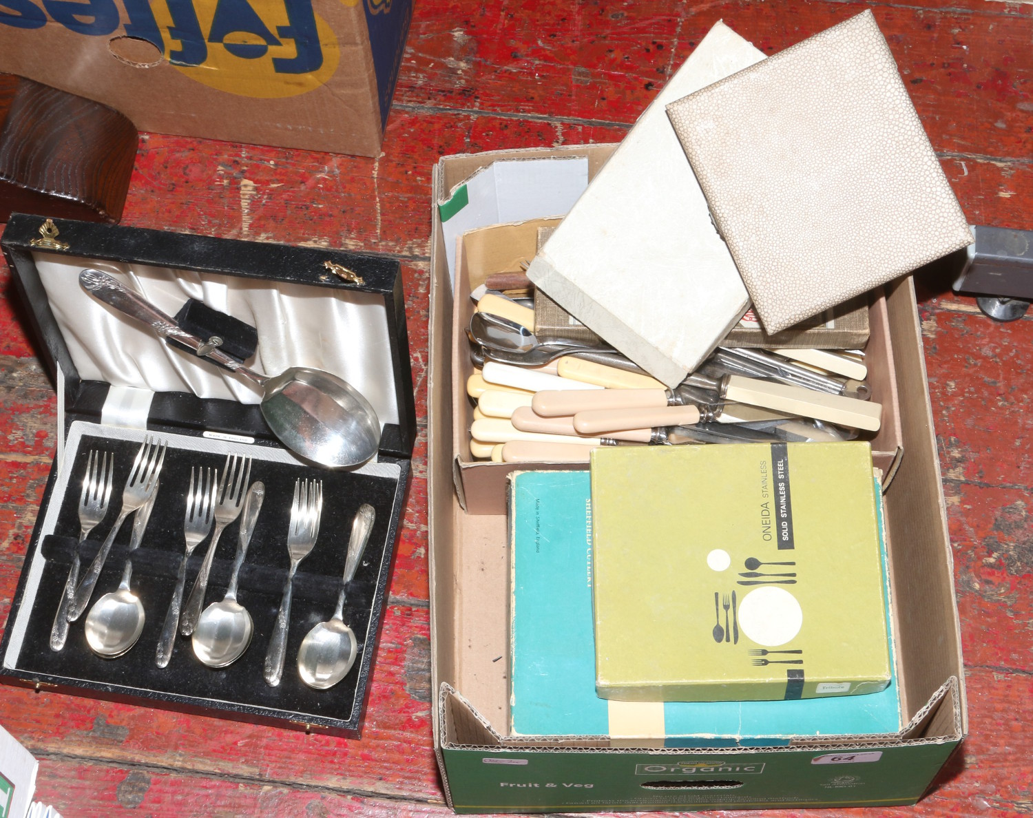 A box of assorted cased and loose flatwares.