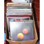 A box of L.P records rock and pop including T-Rex, Police, Eagles, Wings and John Lennon etc.