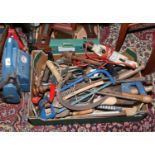 A box of hand tools including saws, electric hammer drill etc, along with car battery charger.