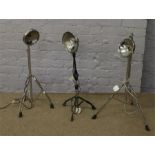 Three upcycled standard lamps formed from drumkit cymbal stands.