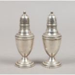 A pair of sterling silver pepperettes.